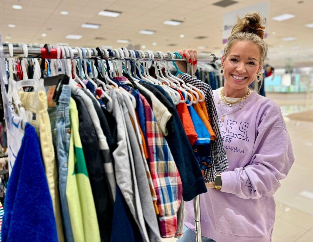 Two friends shop together—one mom wears her baby girl—as they find great deals at their local JBF sale.